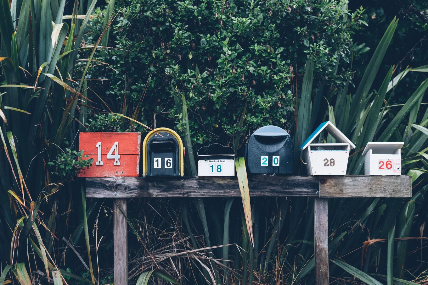 Row of mailboxes with numbers 14, 16, 18, 20, 28, 26.